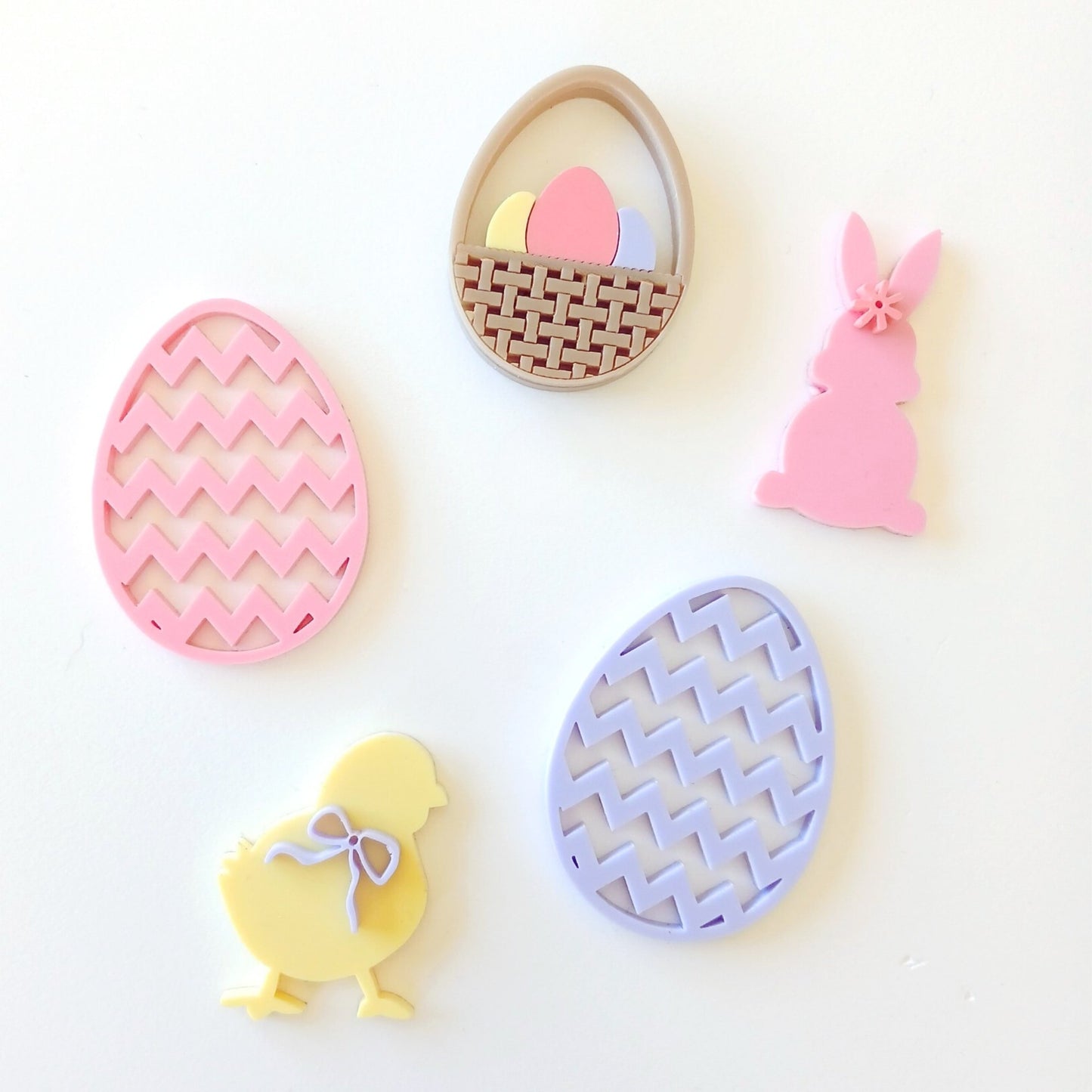 Image of a few of our Easter Bake charms featuring easter egg basket, chick and standup bunny.