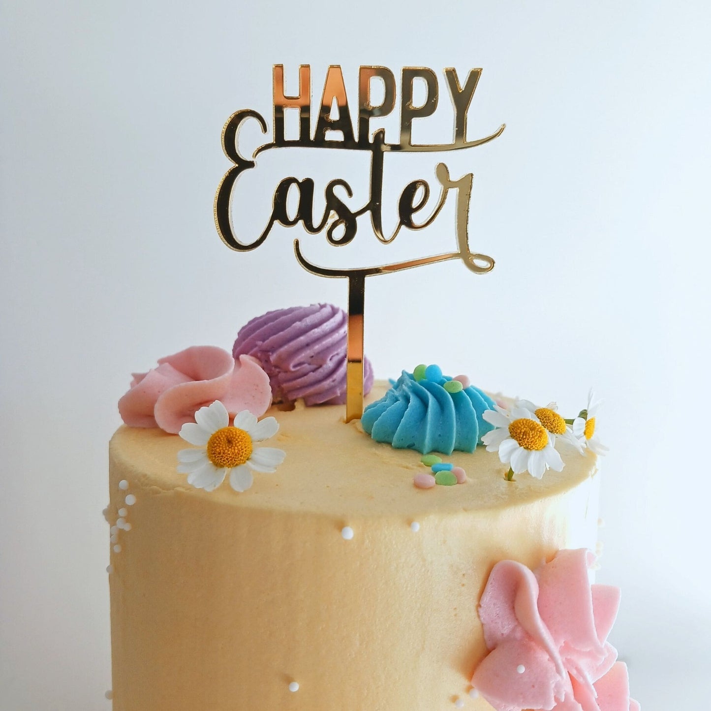 Image of our Gold Mirror Happy Easter Topper on a gorgeous yellow cake.
