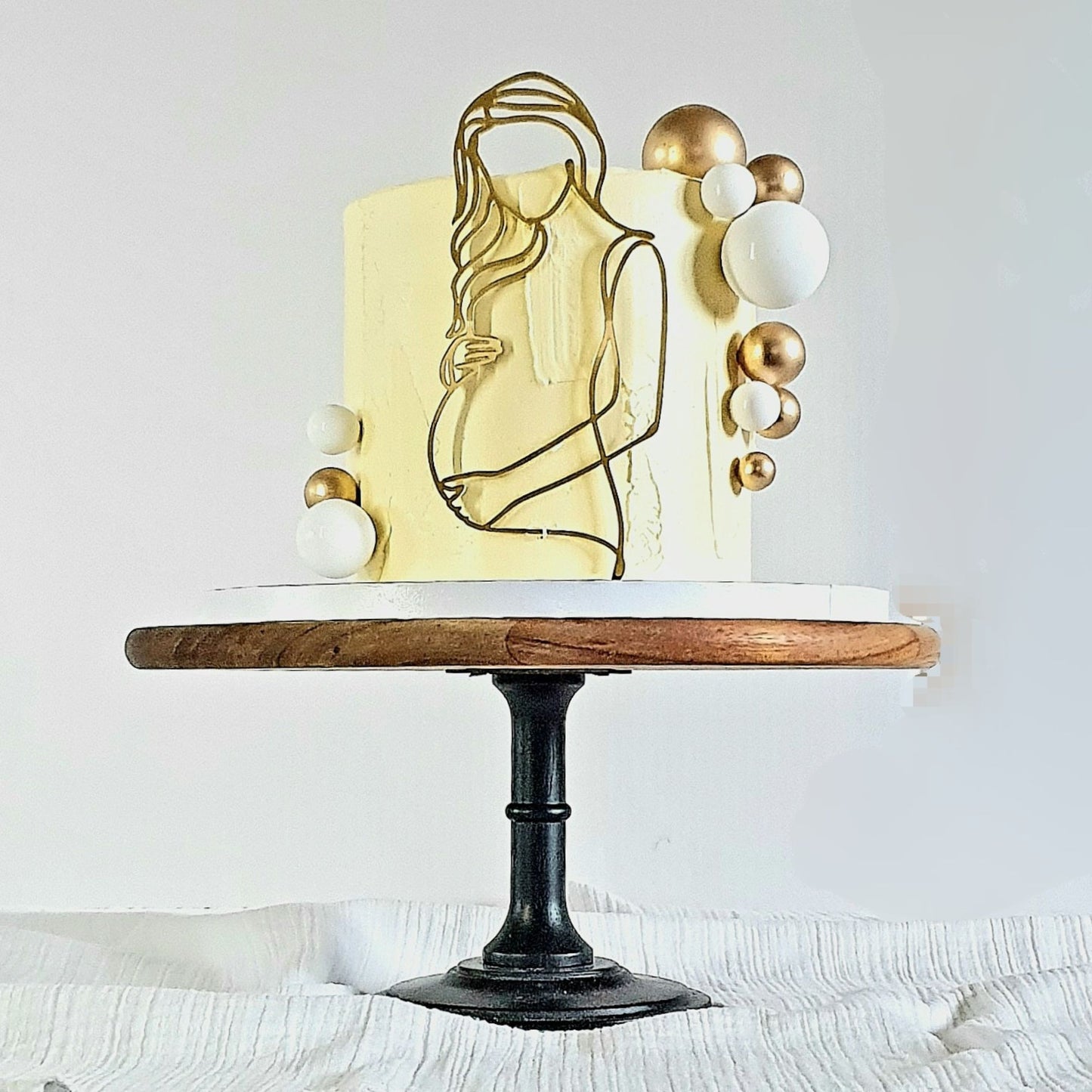 Image of a yellow cake showing a pregnant lady line art Plaque.