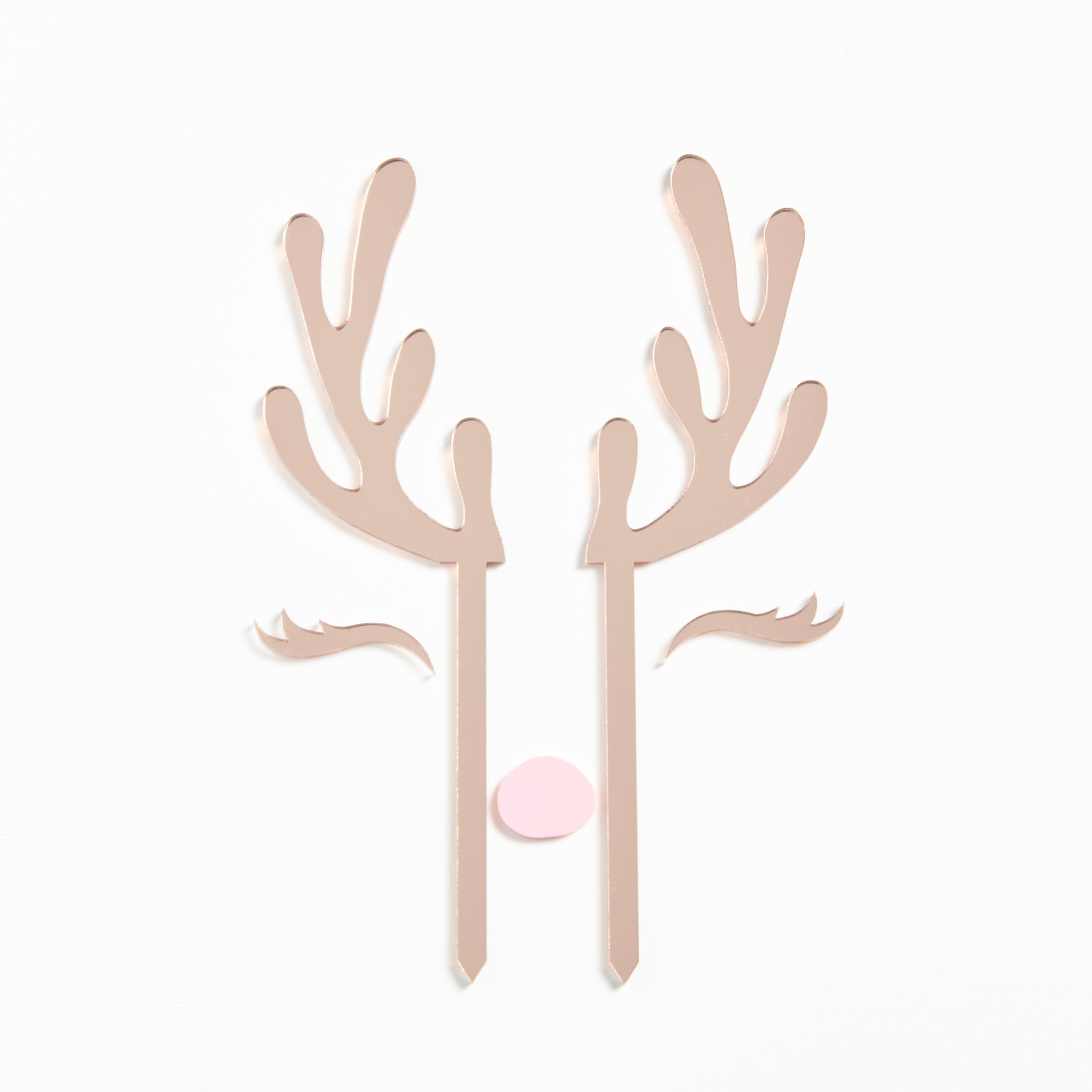 Product Photo of our Reindeer Cake Topper set in Rose Gold Mirror with a pastel pink nose.