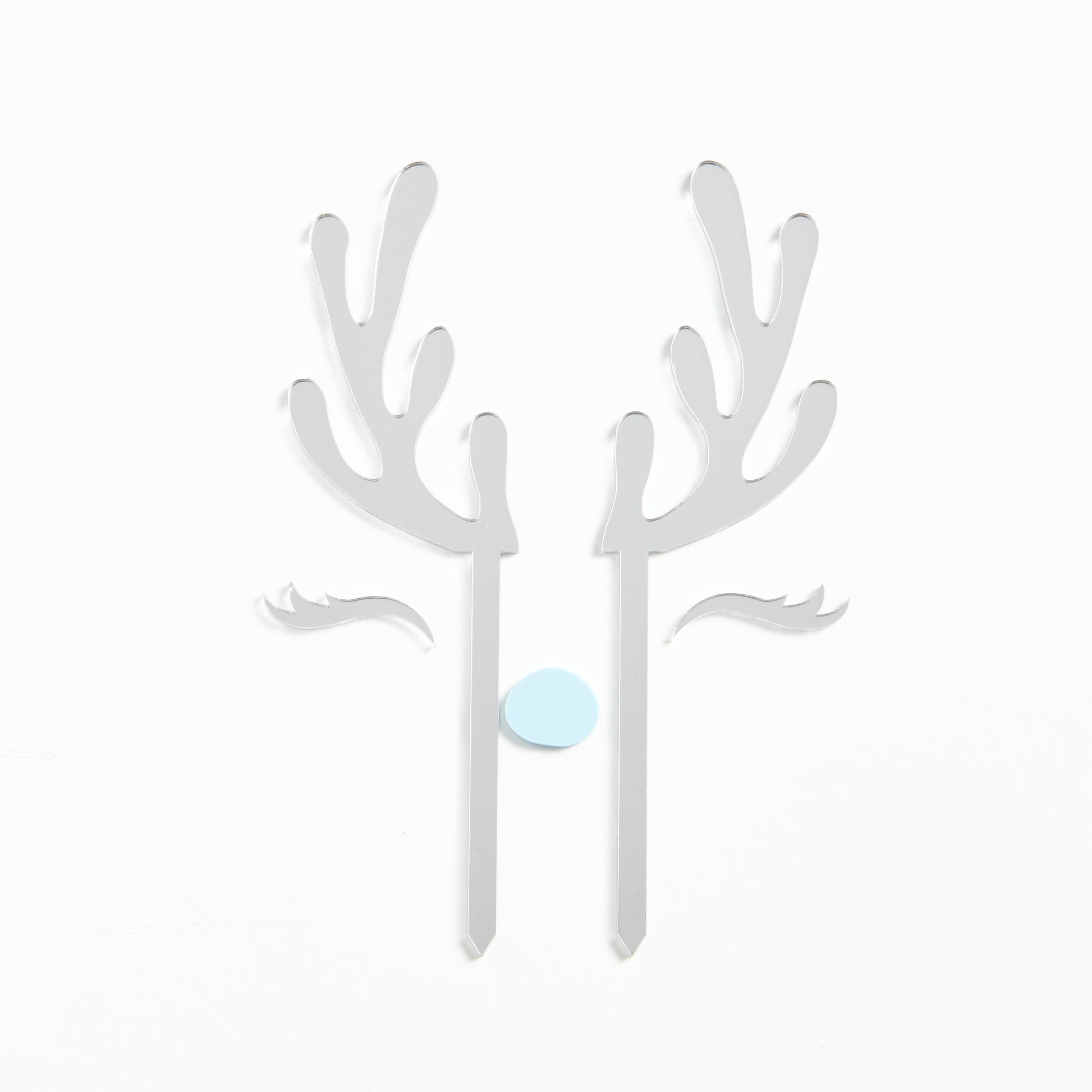 Product Photo of our Reindeer Cake Topper set in Silver Mirror with a pastel blue nose.