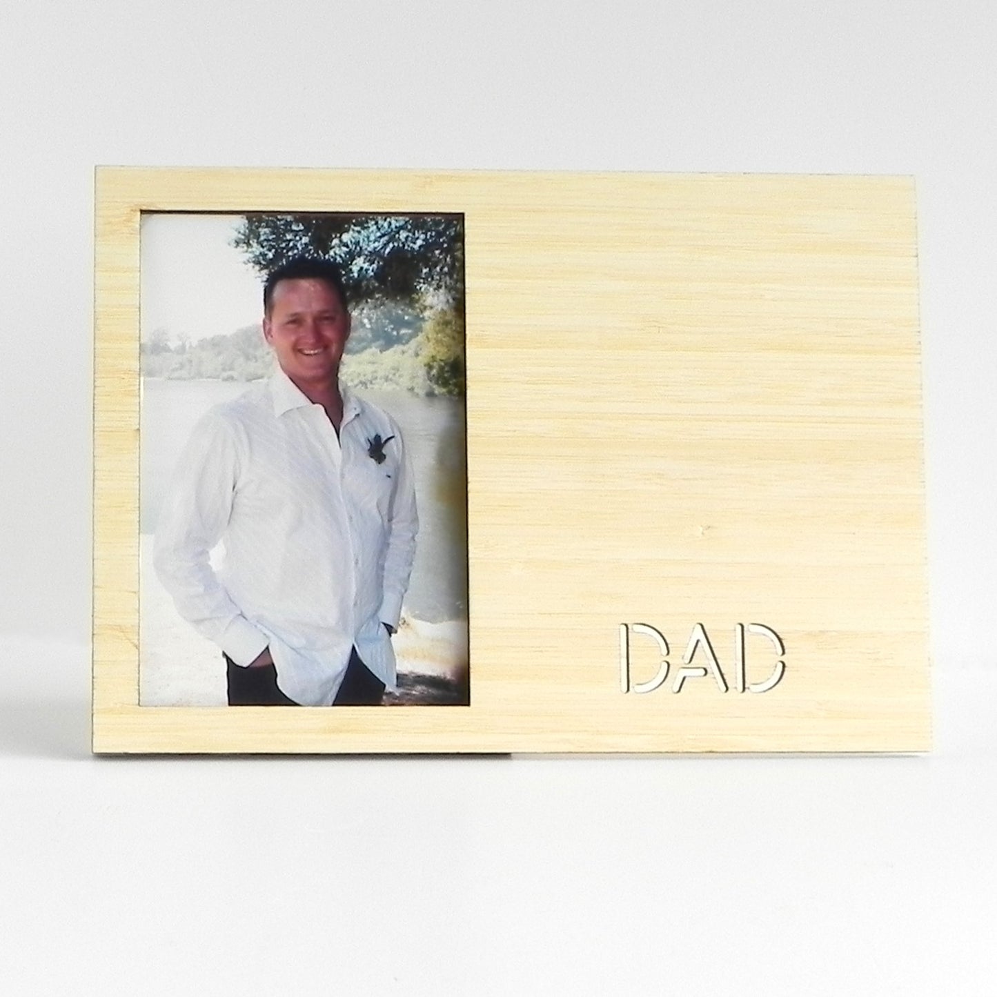 A Photo of a photo frame made from 3mm bamboo and laser cut with the words Dad.