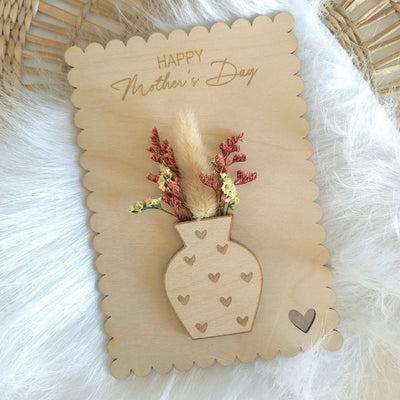 Beautiful wooden mothers day plaque with a small bunch of dried flowers.