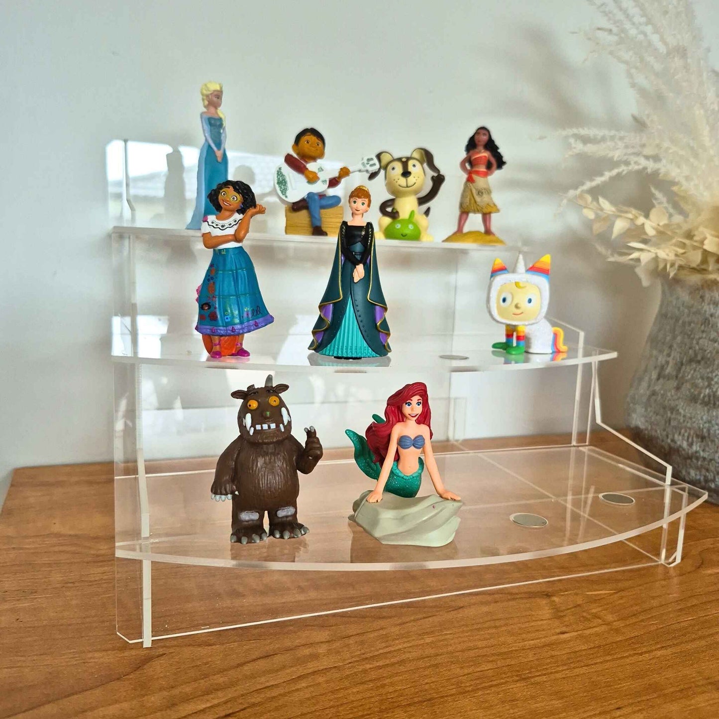 Collection of animated Tonie figurines on a clear acrylic stand.