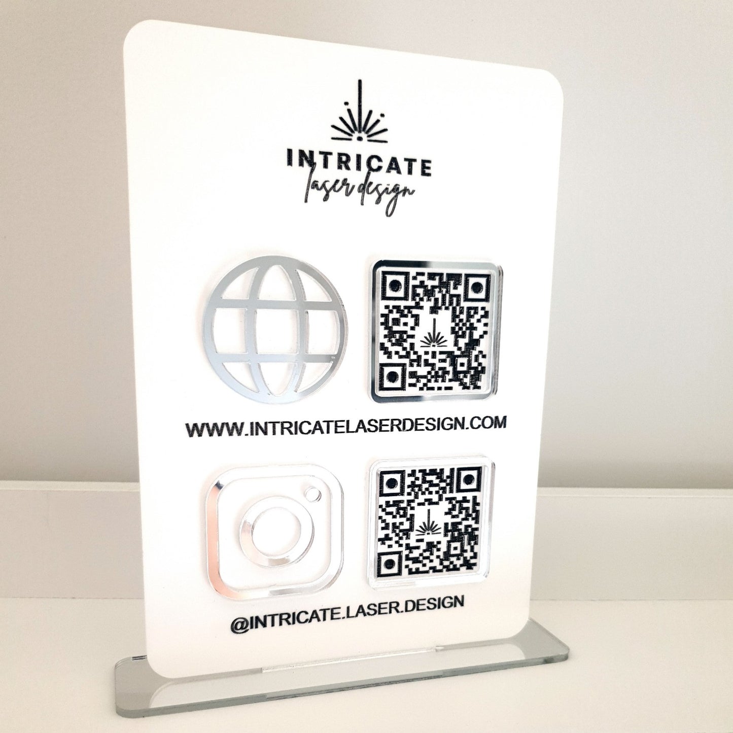 A5 size sign in White Matte Acrylic and Silver Mirror accents.  Showing QR codes for Intricate Laser Designs Website and Instagram profile. 