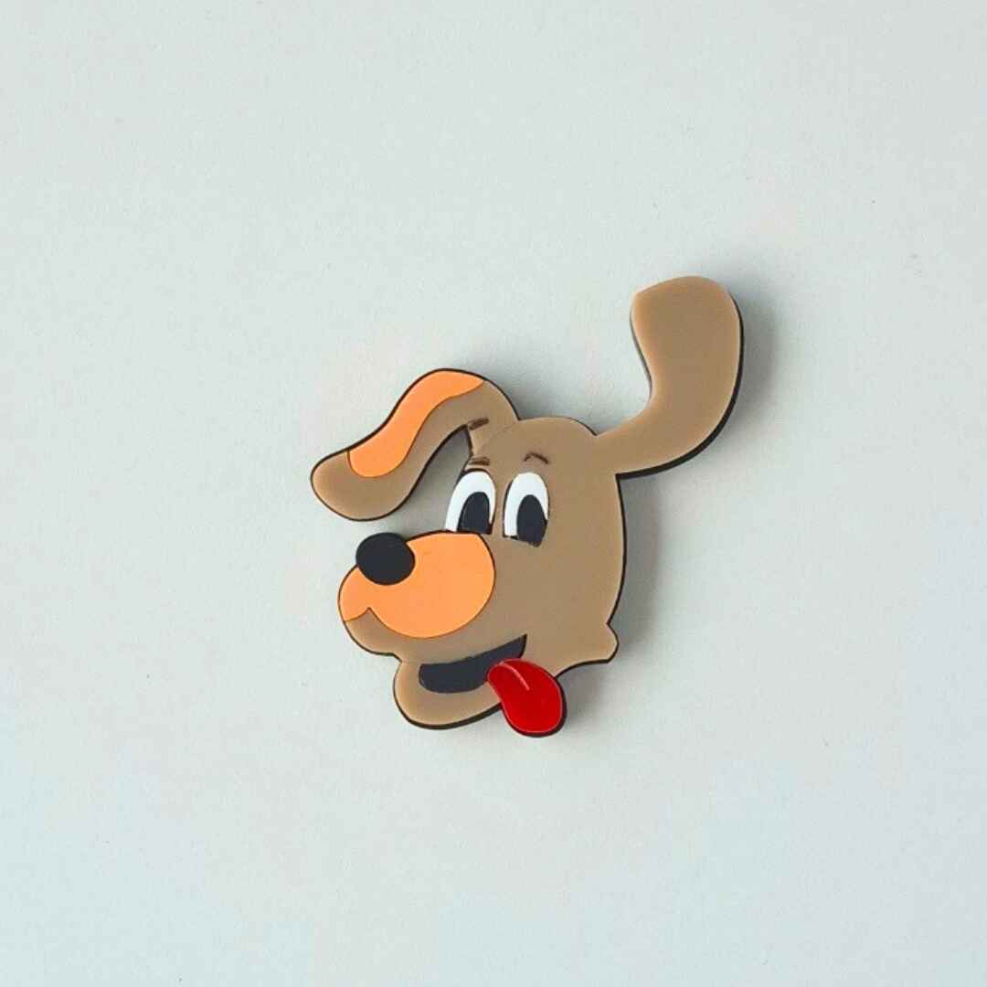 Cartoon dog face charm on a white background