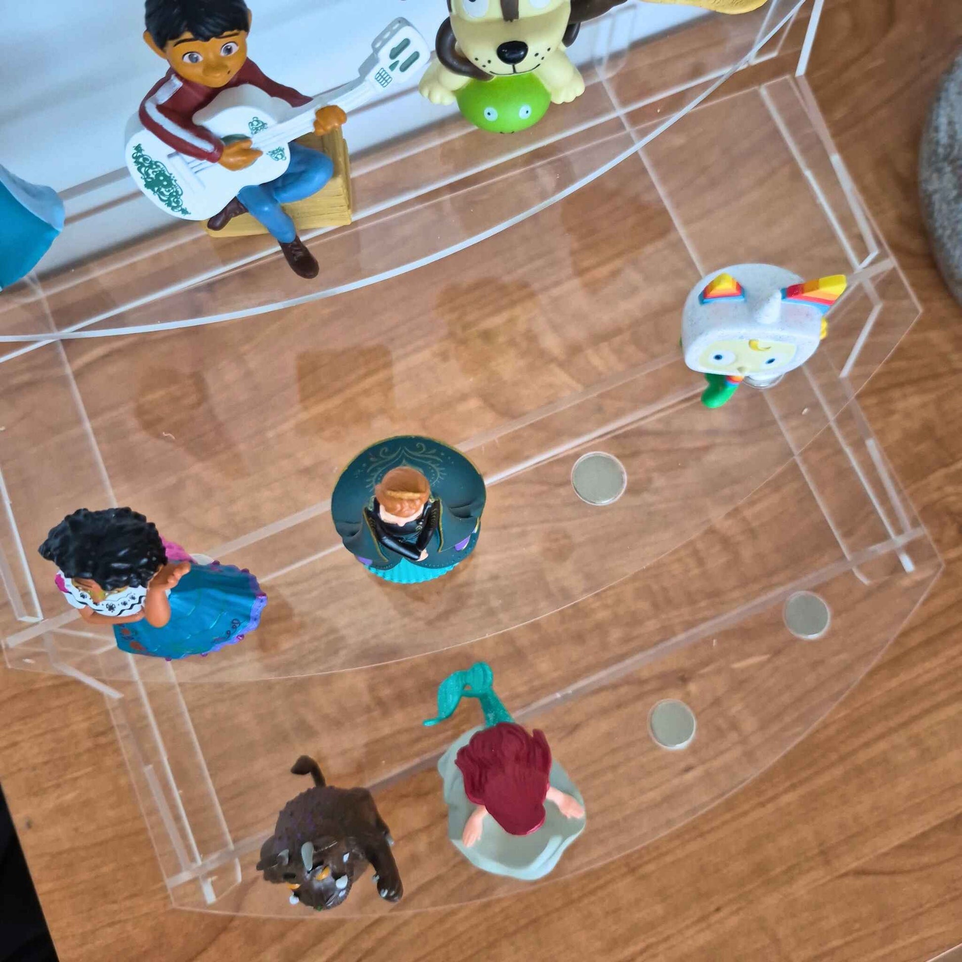 Collection of small figurines on a transparent stand.